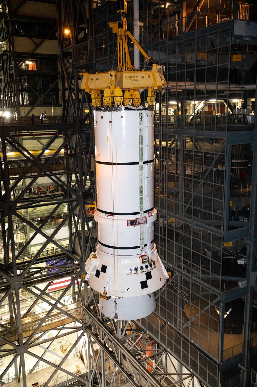 In the Vehicle Assembly Building (VAB) at NASA’s Kennedy Space Center in Florida, the second of two Artemis I aft booster segments for the Space Launch System is lifted high in the transfer aisle for its move into High Bay 3 on Nov. 24, 2020. Workers with Exploration Ground Systems and contractor Jacobs teams will stack the twin five-segment boosters on the mobile launcher in High Bay 3 over a number of weeks. When the core stage arrives, it will join the boosters on the mobile launcher, followed by the interim cryogenic propulsion stage and Orion spacecraft. Manufactured by Northrop Grumman in Utah, the twin boosters provide more than 75 percent of the total SLS thrust at launch. The SLS is managed by Marshall Space Flight Center in Huntsville, Alabama. Under the Artemis program, NASA will land the first woman and the next man on the Moon by 2024. The first in a series of increasingly complex missions, Artemis I will test the Orion spacecraft and SLS as an integrated system ahead of crewed flights to the Moon.