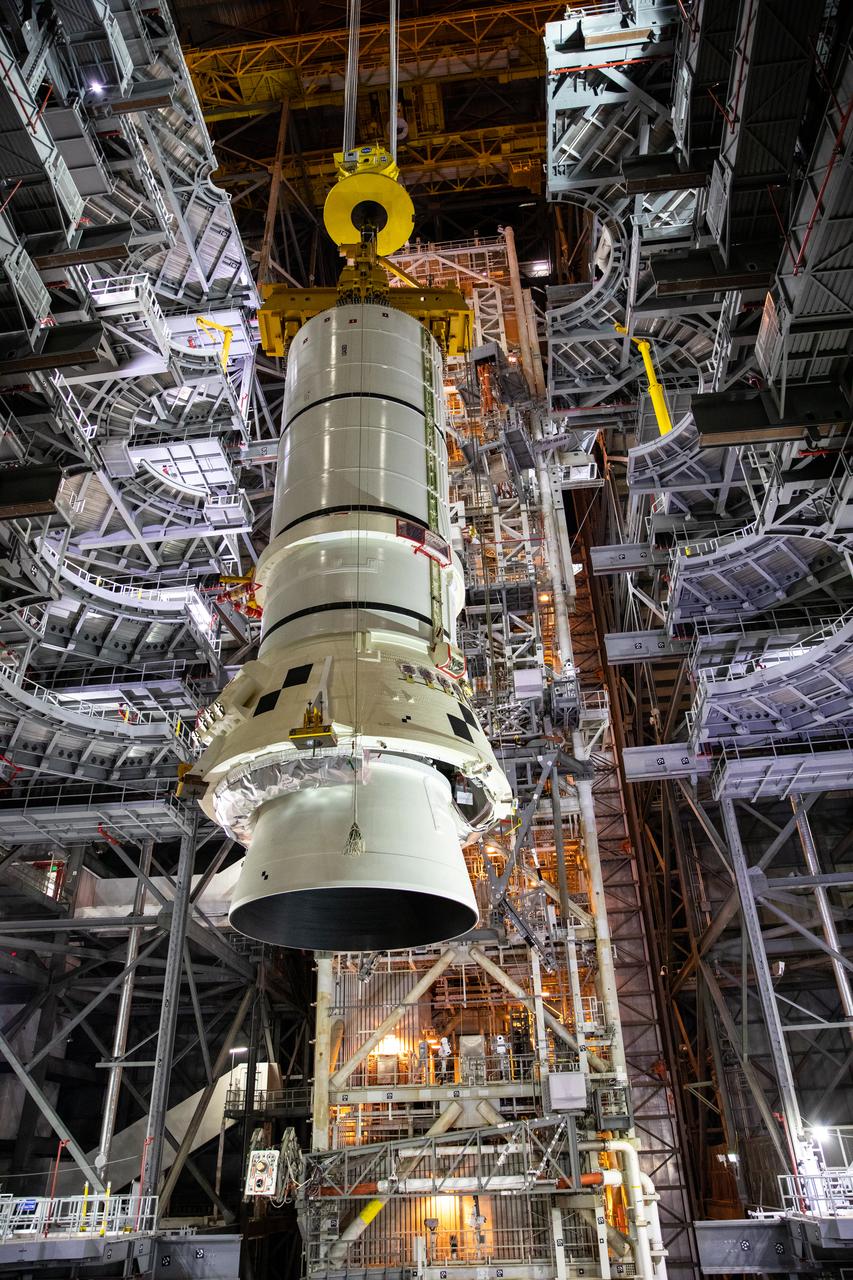 In the Vehicle Assembly Building (VAB) at NASA’s Kennedy Space Center in Florida, the second of two Artemis I aft booster segments for the Space Launch System is lowered by crane into High Bay 3 on Nov. 24, 2020. Workers with Exploration Ground Systems and contractor Jacobs teams will stack the twin five-segment boosters on the mobile launcher in High Bay 3 over a number of weeks. When the core stage arrives, it will join the boosters on the mobile launcher, followed by the interim cryogenic propulsion stage and Orion spacecraft. Manufactured by Northrop Grumman in Utah, the twin boosters provide more than 75 percent of the total SLS thrust at launch. The SLS is managed by Marshall Space Flight Center in Huntsville, Alabama. Under the Artemis program, NASA will land the first woman and the next man on the Moon by 2024. The first in a series of increasingly complex missions, Artemis I will test the Orion spacecraft and SLS as an integrated system ahead of crewed flights to the Moon.