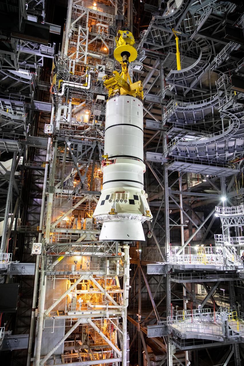 In the Vehicle Assembly Building (VAB) at NASA’s Kennedy Space Center in Florida, the second of two Artemis I aft booster segments for the Space Launch System is lowered by crane into High Bay 3 on Nov. 24, 2020. Workers with Exploration Ground Systems and contractor Jacobs teams will stack the twin five-segment boosters on the mobile launcher in High Bay 3 over a number of weeks. When the core stage arrives, it will join the boosters on the mobile launcher, followed by the interim cryogenic propulsion stage and Orion spacecraft. Manufactured by Northrop Grumman in Utah, the twin boosters provide more than 75 percent of the total SLS thrust at launch. The SLS is managed by Marshall Space Flight Center in Huntsville, Alabama. Under the Artemis program, NASA will land the first woman and the next man on the Moon by 2024. The first in a series of increasingly complex missions, Artemis I will test the Orion spacecraft and SLS as an integrated system ahead of crewed flights to the Moon.