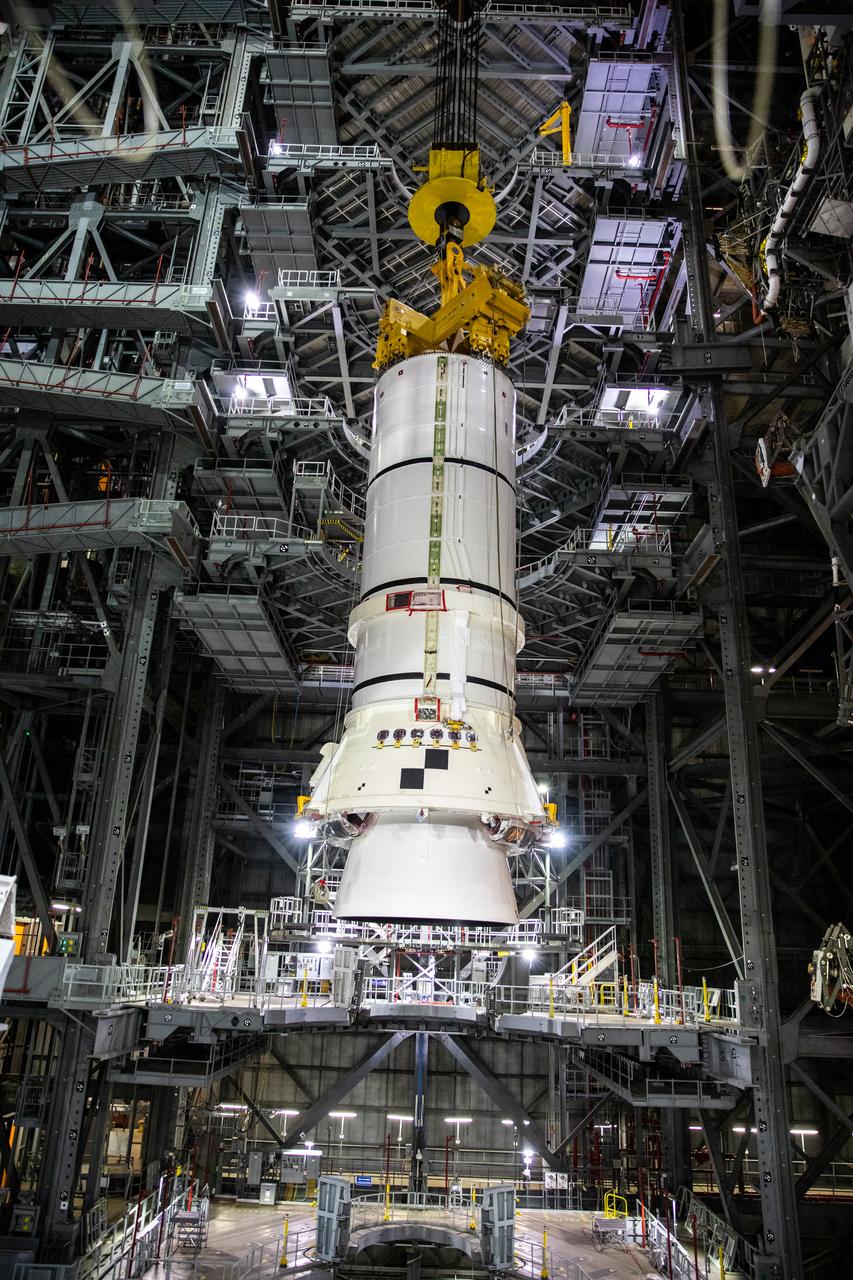 In the Vehicle Assembly Building (VAB) at NASA’s Kennedy Space Center in Florida, the second of two Artemis I aft booster segments for the Space Launch System is lowered by crane into High Bay 3 on Nov. 24, 2020. Workers with Exploration Ground Systems and contractor Jacobs teams will stack the twin five-segment boosters on the mobile launcher in High Bay 3 over a number of weeks. When the core stage arrives, it will join the boosters on the mobile launcher, followed by the interim cryogenic propulsion stage and Orion spacecraft. Manufactured by Northrop Grumman in Utah, the twin boosters provide more than 75 percent of the total SLS thrust at launch. The SLS is managed by Marshall Space Flight Center in Huntsville, Alabama. Under the Artemis program, NASA will land the first woman and the next man on the Moon by 2024. The first in a series of increasingly complex missions, Artemis I will test the Orion spacecraft and SLS as an integrated system ahead of crewed flights to the Moon.
