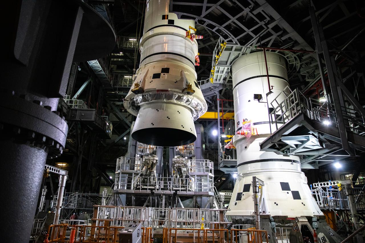 In the Vehicle Assembly Building (VAB) at NASA’s Kennedy Space Center in Florida, the second of two Artemis I aft booster segments for the Space Launch System is lowered by crane onto the mobile launcher in High Bay 3 on Nov. 24, 2020. Workers with Exploration Ground Systems and contractor Jacobs teams will stack the twin five-segment boosters on the mobile launcher over a number of weeks. When the core stage arrives, it will join the boosters on the mobile launcher, followed by the interim cryogenic propulsion stage and Orion spacecraft. Manufactured by Northrop Grumman in Utah, the twin boosters provide more than 75 percent of the total SLS thrust at launch. The SLS is managed by Marshall Space Flight Center in Huntsville, Alabama. Under the Artemis program, NASA will land the first woman and the next man on the Moon by 2024. The first in a series of increasingly complex missions, Artemis I will test the Orion spacecraft and SLS as an integrated system ahead of crewed flights to the Moon.