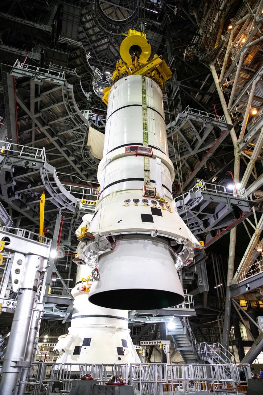 In the Vehicle Assembly Building (VAB) at NASA’s Kennedy Space Center in Florida, the second of two Artemis I aft booster segments for the Space Launch System is lowered by crane onto the mobile launcher in High Bay 3 on Nov. 24, 2020. Workers with Exploration Ground Systems and contractor Jacobs teams will stack the twin five-segment boosters on the mobile launcher over a number of weeks. When the core stage arrives, it will join the boosters on the mobile launcher, followed by the interim cryogenic propulsion stage and Orion spacecraft. Manufactured by Northrop Grumman in Utah, the twin boosters provide more than 75 percent of the total SLS thrust at launch. The SLS is managed by Marshall Space Flight Center in Huntsville, Alabama. Under the Artemis program, NASA will land the first woman and the next man on the Moon by 2024. The first in a series of increasingly complex missions, Artemis I will test the Orion spacecraft and SLS as an integrated system ahead of crewed flights to the Moon.