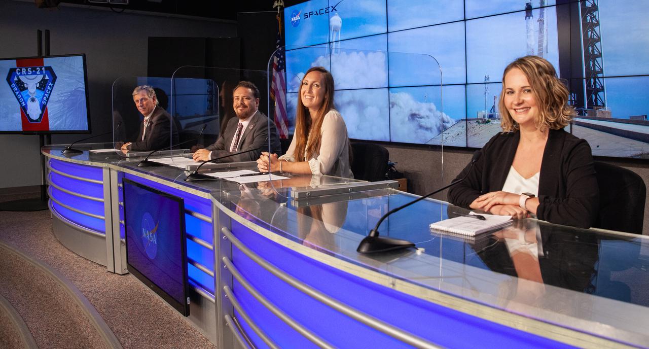 From left, Kenny Todd, deputy program manager, International Space Station Program Office; Kirt Costello, chief scientist, International Space Station Program Office; Sarah Walker, director, Dragon Mission Management, SpaceX; and Melody Lovin, launch weather officer, U.S. Air Force 45th Space Wing, participate in a CRS-21 prelaunch news conference at Kennedy Space Center in Florida on Dec. 4, 2020. NASA Communications’ Jasmine Hopkins moderated the event. SpaceX’s Falcon 9 rocket, with the upgraded version of the Cargo Dragon spacecraft atop, is targeted to lift off from Kennedy’s Launch Complex 39A Saturday, Dec. 5, at 11:39 a.m. EST. CRS-21 will deliver supplies, equipment, and critical materials needed to support a variety of science and research investigations on the International Space Station.