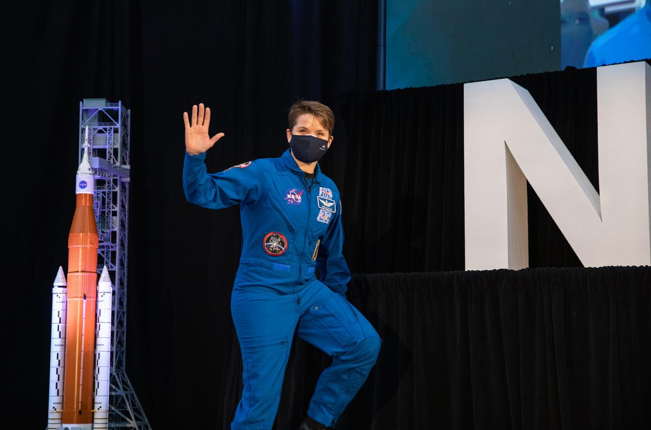NASA astronaut Anne McClain waves during an announcement Dec. 9, 2020, that she is one of the initial team of 18 astronauts eligible for early Artemis missions on and around the Moon. A Washington native, McClain was selected as a NASA astronaut in 2013 and has spent 204 days in space on one previous flight. Joining her at the event were fellow astronauts Joseph Acaba, Matthew Dominick, Jessica Meir, and Jessica Watkins. Vice President Mike Pence made the announcement at the close of a National Space Council meeting he chaired in the Apollo/Saturn V Center at the Kennedy Space Center Visitor Complex in Florida. Under the Artemis program, NASA will land the first woman and the next man on the Moon in 2024.