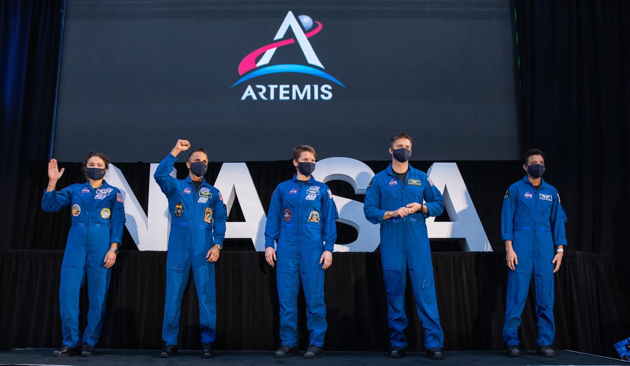 From left, NASA astronauts Jessica Meir, Joseph Acaba, Anne McClain, Matthew Dominick, and Jessica Watkins are introduced during a National Space Council meeting inside the Apollo/Saturn V Center at the Kennedy Space Center Visitor Complex in Florida on Dec. 9, 2020. The five are among an initial team of 18 astronauts eligible for early Artemis missions on and around the Moon. Vice President Mike Pence, who chaired the meeting, introduced the astronauts. Under the Artemis program, NASA will land the first woman and the next man on the Moon in 2024.