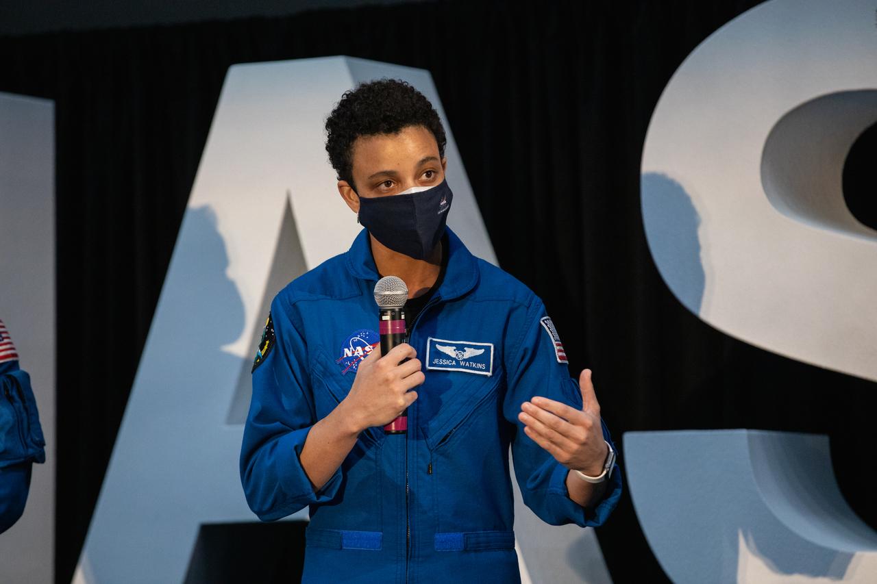 NASA astronaut Jessica Watkins speaks to members of the news media during a question-and-answer session Dec. 9, 2020, following a National Space Council meeting inside the Apollo/Saturn V Center at the Kennedy Space Center Visitor Complex in Florida. Vice President Mike Pence chaired the meeting, at which he announced the initial team of 18 astronauts eligible for early Artemis missions on and around the Moon. A Colorado native, Watkins was selected as a NASA astronaut in 2017. She was joined at the event by fellow astronauts Joseph Acaba, Matthew Dominick, Jessica Meir, and Anne McClain. Under the Artemis program, NASA will land the first woman and the next man on the Moon in 2024.