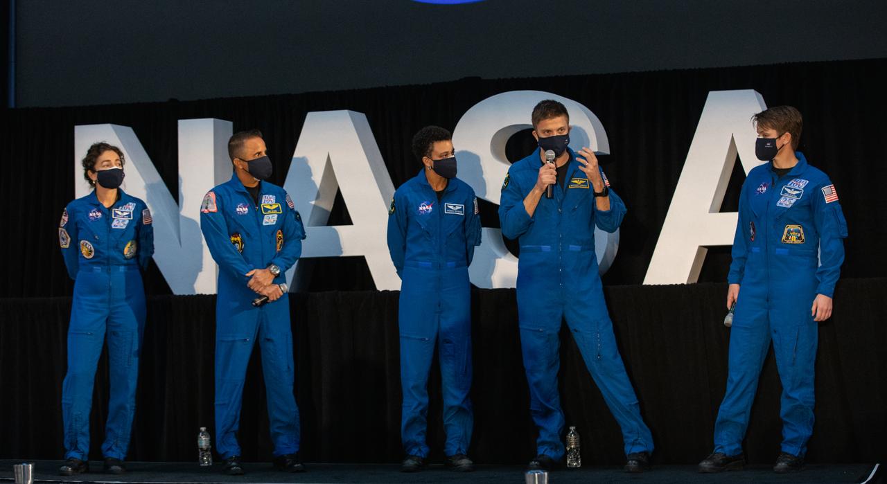 NASA astronaut Matthew Dominick, second from right, speaks to members of the news media during a question-and-answer session Dec. 9, 2020, following a National Space Council meeting inside the Apollo/Saturn V Center at the Kennedy Space Center Visitor Complex in Florida. Vice President Mike Pence chaired the meeting at which he announced the initial team of 18 astronauts eligible for early Artemis missions on and around the Moon. A Colorado native, Dominick was selected as a NASA astronaut in 2017. He was joined at the event by fellow astronauts, from left, Jessica Meir, Joseph Acaba, Jessica Watkins, and Anne McClain. Under the Artemis program, NASA will land the first woman and the next man on the Moon in 2024.