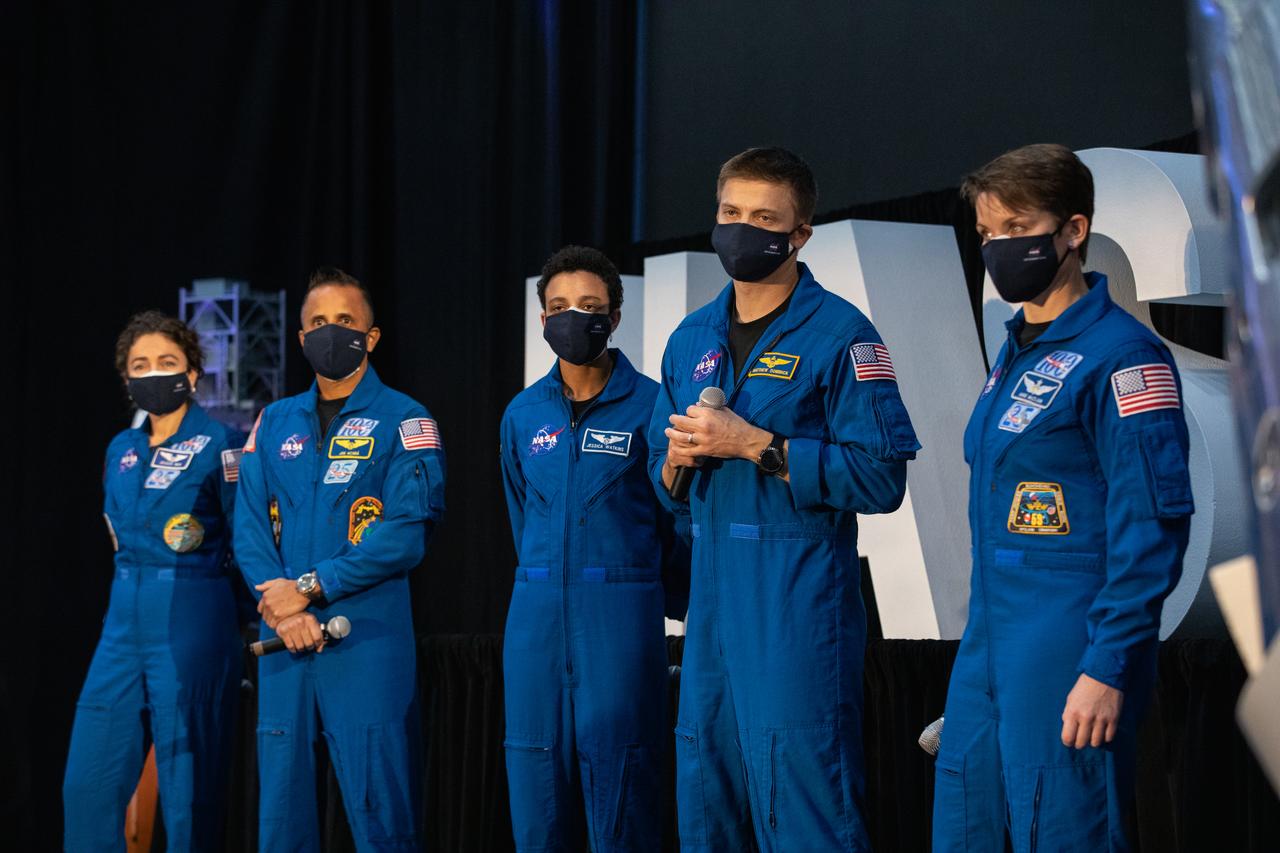 NASA astronaut Matthew Dominick, second from right, listens to a question from a member of the news media during a question-and-answer session Dec. 9, 2020, following a National Space Council meeting inside the Apollo/Saturn V Center at the Kennedy Space Center Visitor Complex in Florida. Vice President Mike Pence chaired the meeting at which he announced the initial team of 18 astronauts eligible for early Artemis missions on and around the Moon. A Colorado native, Dominick was selected as a NASA astronaut in 2017. He was joined at the event by fellow astronauts, from left, Jessica Meir, Joseph Acaba, Jessica Watkins, and Anne McClain. Under the Artemis program, NASA will land the first woman and the next man on the Moon in 2024.