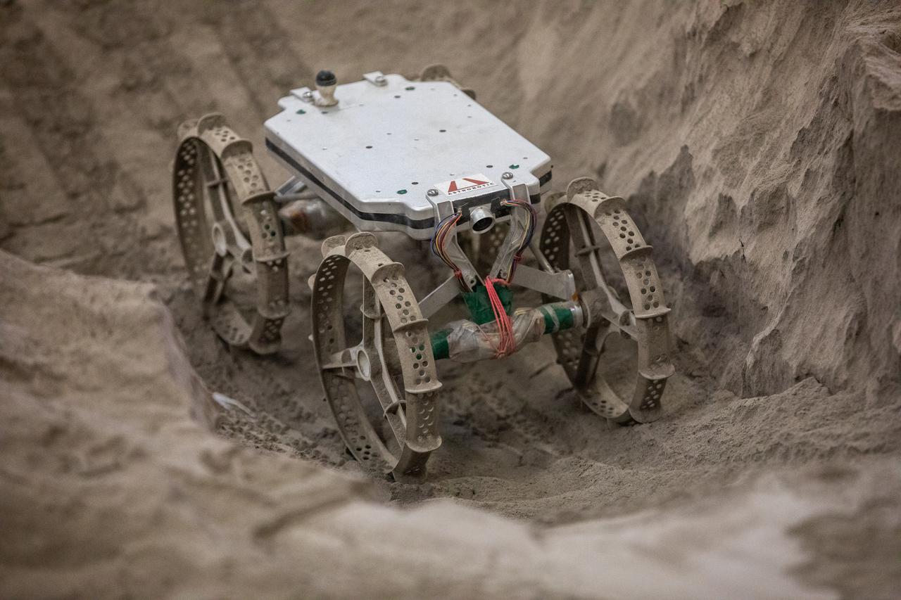 The Astrobotic CubeRover traverses the terrain in the Granular Mechanics and Regolith Operations Laboratory regolith bin at NASA’s Kennedy Space Center in Florida on Dec. 10, 2020. The regolith bin simulates the mechanical properties of the Moon’s surface. NASA and Astrobotic employees put the CubeRover through a series of more than 150 mobility tests over several days to evaluate and improve wheel design.