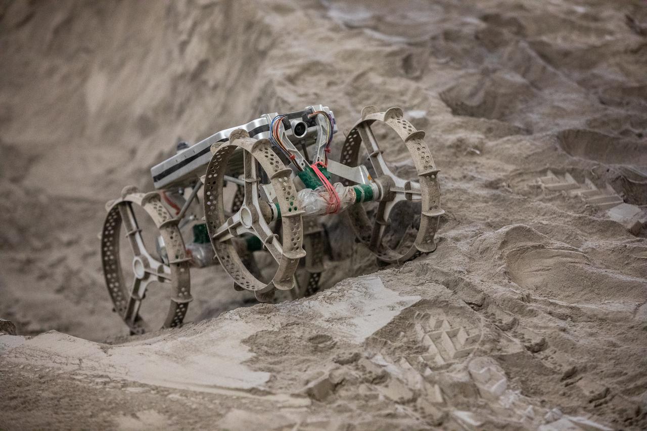 The Astrobotic CubeRover traverses the terrain in the Granular Mechanics and Regolith Operations Laboratory regolith bin at NASA’s Kennedy Space Center in Florida on Dec. 10, 2020. The regolith bin simulates the mechanical properties of the Moon’s surface. NASA and Astrobotic employees put the CubeRover through a series of more than 150 mobility tests over several days to evaluate and improve wheel design.