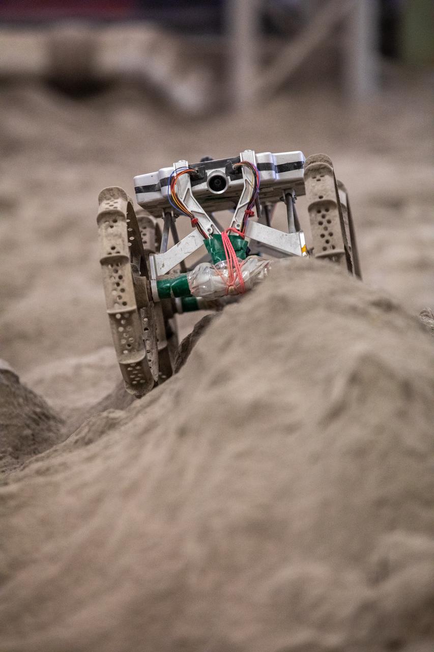 The Astrobotic CubeRover traverses obstacles in the Granular Mechanics and Regolith Operations Laboratory regolith bin at NASA’s Kennedy Space Center in Florida on Dec. 10, 2020. The regolith bin simulates the mechanical properties of the Moon’s surface. NASA and Astrobotic employees put the CubeRover through a series of more than 150 mobility tests over several days to evaluate and improve wheel design.