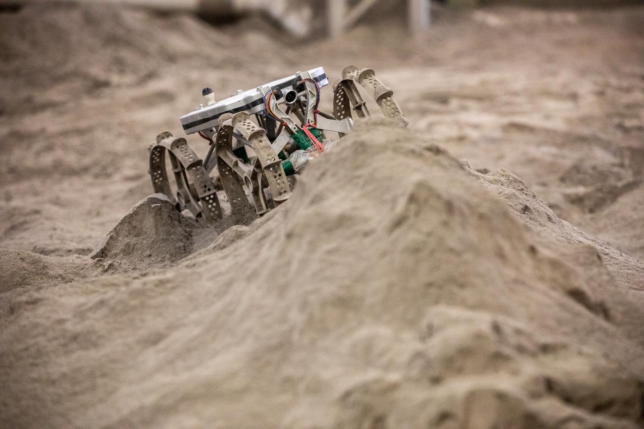 The Astrobotic CubeRover traverses obstacles in the Granular Mechanics and Regolith Operations Laboratory regolith bin at NASA’s Kennedy Space Center in Florida on Dec. 10, 2020. The regolith bin simulates the mechanical properties of the Moon’s surface. NASA and Astrobotic employees put the CubeRover through a series of more than 150 mobility tests over several days to evaluate and improve wheel design.