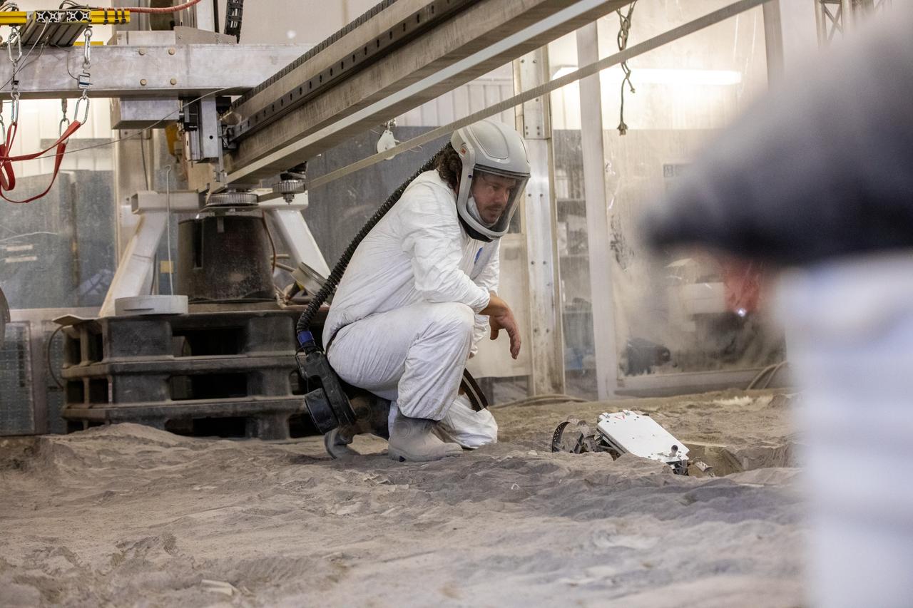 A.J. Nick, with Kennedy Space Center’s Exploration and Research and Technology programs, checks the Astrobotic CubeRover during its test run in the regolith bin at Kennedy on Dec. 10, 2020. The regolith bin simulates the mechanical properties of the Moon’s surface. NASA and Astrobotic employees put the CubeRover through a series of more than 150 mobility tests over several days to evaluate and improve wheel design.