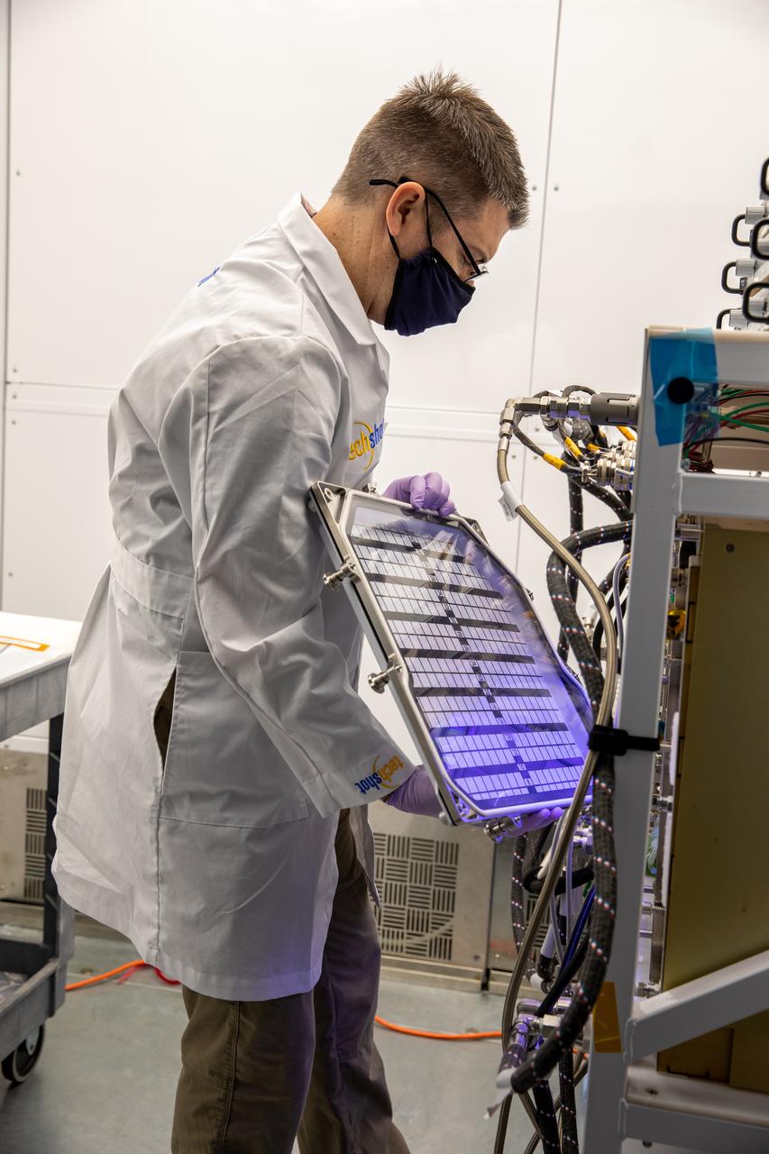A researcher prepares to harvest radishes grown in the Advanced Plant Habitat (APH) ground unit inside the Space Station Processing Facility at NASA’s Kennedy Space Center in Florida on Dec. 14, 2020. The radishes are a ground control crop for the Plant Habitat-02 (PH-02) experiment, which also involves growing two radish crops inside the International Space Station’s APH. NASA astronaut Kate Rubins harvested the first crop on Nov. 30, and the second harvest aboard the orbiting laboratory is planned for Dec. 30. Once samples return to Earth, researchers will compare those grown in space to the radishes grown here on Earth to better understand how microgravity affects plant growth. 