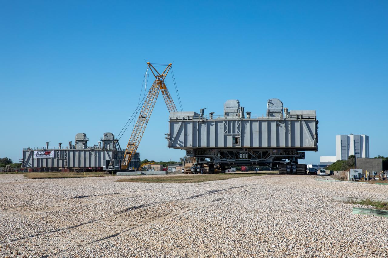 The two mobile launcher platforms (MLPs) are seen at the MSS park site at NASA’s Kennedy Space Center in Florida on Jan. 4, 2021. One MLP is undergoing crawlerway conditioning – a several month-long project to ensure the path the rocket takes from the VAB to the launch pad is strong enough to support the weight for the upcoming Artemis I launch. The other MLP used during the shuttle program is in the process of being demolished.