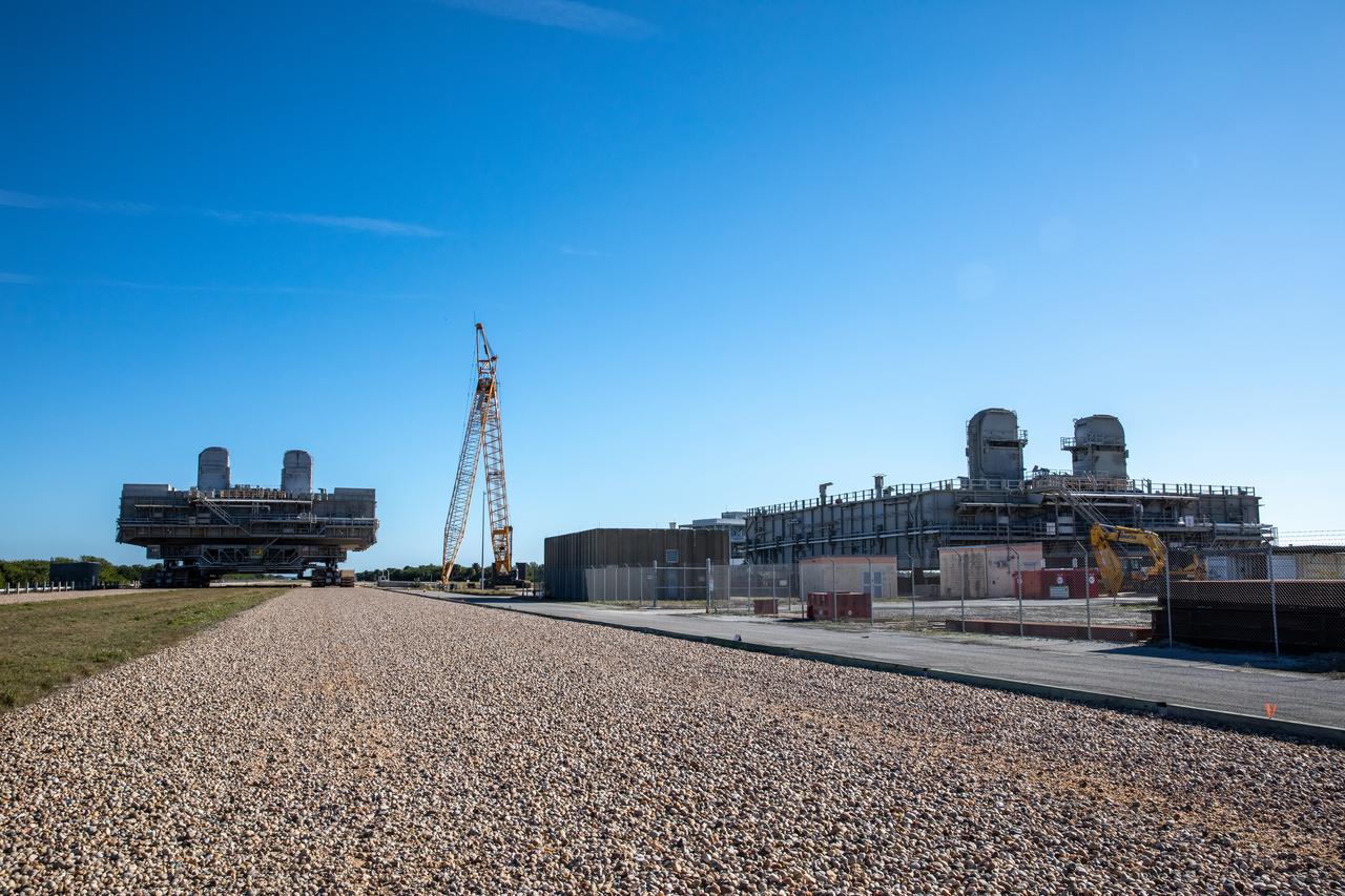 The two mobile launcher platforms (MLPs) are seen at the MSS park site at NASA’s Kennedy Space Center in Florida on Jan. 4, 2021. One MLP is undergoing crawlerway conditioning – a several month-long project to ensure the path the rocket takes from the VAB to the launch pad is strong enough to support the weight for the upcoming Artemis I launch. The other MLP used during the shuttle program is in the process of being demolished.