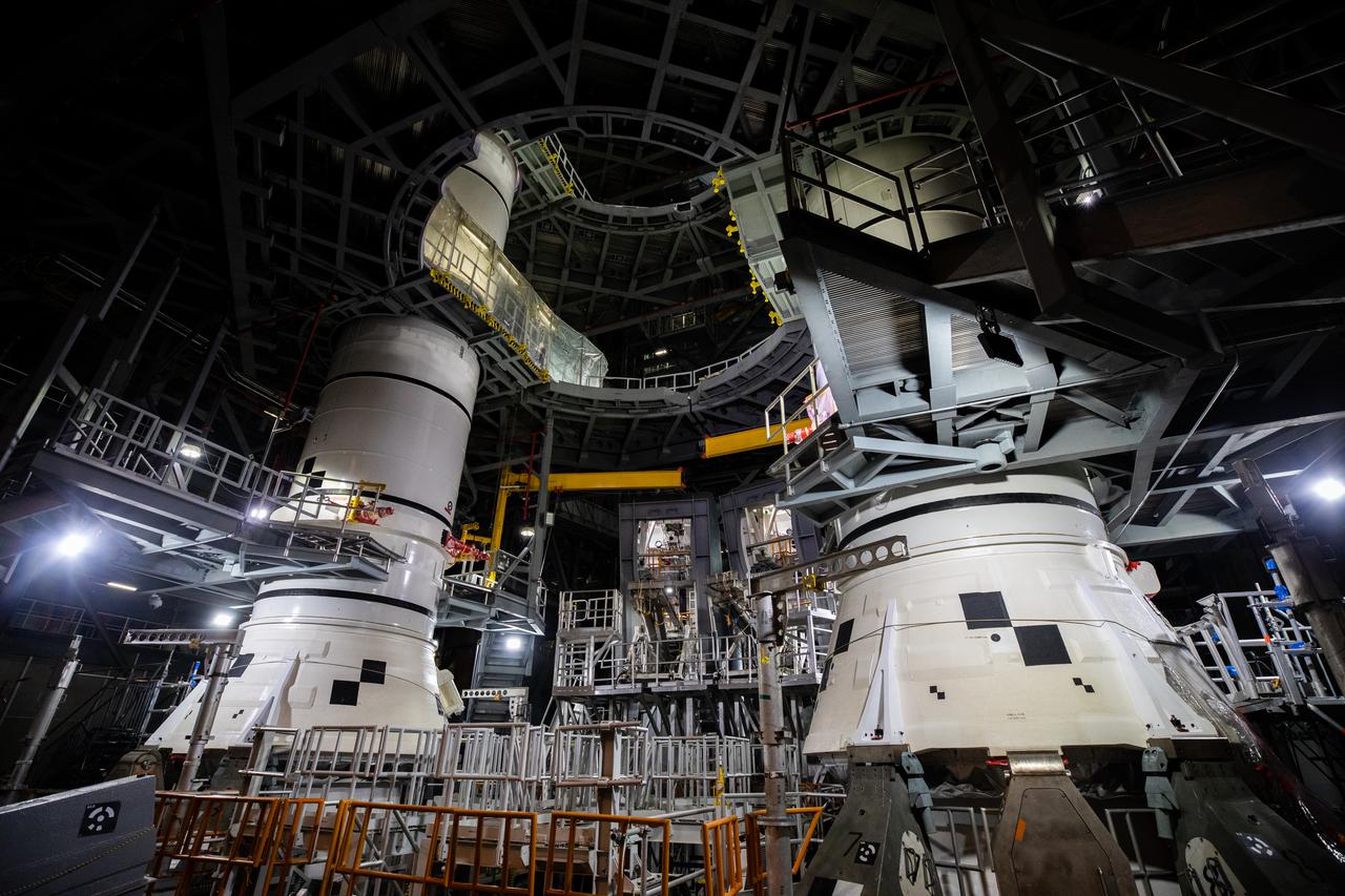 In High Bay 3 of the Vehicle Assembly Building at NASA’s Kennedy Space Center in Florida, the right-hand center aft booster segment for Artemis I is lowered onto the aft booster segment on the mobile launcher for the Space Launch System (SLS) on Jan. 12, 2021. Also in view at left, is the left-hand booster stack. Workers with Exploration Ground Systems and contractor Jacobs teams will stack the twin five-segment boosters on the mobile launcher in High Bay 3 over a number of weeks. When the core stage arrives, it will join the boosters on the mobile launcher, followed by the interim cryogenic propulsion stage and Orion spacecraft. Manufactured by Northrop Grumman in Utah, the twin boosters provide more than 75 percent of the total SLS thrust at launch. The SLS is managed by Marshall Space Flight Center in Huntsville, Alabama. Under the Artemis program, NASA will land the first woman and the next man on the Moon by 2024. The first in a series of increasingly complex missions, Artemis I will test the Orion spacecraft and SLS as an integrated system ahead of crewed flights to the Moon.