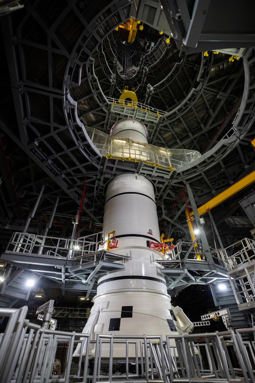 In High Bay 3 of the Vehicle Assembly Building at NASA’s Kennedy Space Center in Florida, the right-hand center aft booster segment for Artemis I is lowered onto the aft booster segment on the mobile launcher for the Space Launch System (SLS) on Jan. 12, 2021. Workers with Exploration Ground Systems and contractor Jacobs teams will stack the twin five-segment boosters on the mobile launcher in High Bay 3 over a number of weeks. When the core stage arrives, it will join the boosters on the mobile launcher, followed by the interim cryogenic propulsion stage and Orion spacecraft. Manufactured by Northrop Grumman in Utah, the twin boosters provide more than 75 percent of the total SLS thrust at launch. The SLS is managed by Marshall Space Flight Center in Huntsville, Alabama. Under the Artemis program, NASA will land the first woman and the next man on the Moon by 2024. The first in a series of increasingly complex missions, Artemis I will test the Orion spacecraft and SLS as an integrated system ahead of crewed flights to the Moon.