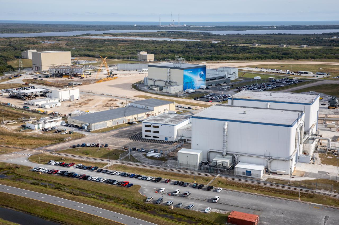 An aerial view of several processing facilities at NASA’s Kennedy Space Center in Florida on Jan. 13, 2021. In view in the background is Boeing’s Commercial Crew and Cargo Processing Facility.