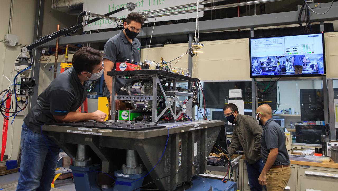 Kennedy Space Center engineers conduct vibration tests inside the Florida spaceport’s Vibration Test Lab on Jan. 14, 2021, in preparation for the suborbital flight of NASA’s Orbital Syngas Commodity Augmentation Reactor, or OSCAR, slated for later this year. From left are Gino Carro, a pressure vessels and systems engineer for the center’s Laboratory Support Services and Operations contract; Ray Pitts, co-principal investigator for OSCAR; David Rinderknecht, NASA chemical engineer; and Malay Shah, NASA thermal/fluid analysis engineer. Beginning as an Early Career Initiative project, OSCAR studies technology to convert trash and human waste into useful gasses such as methane, hydrogen, and carbon dioxide. By processing small pieces of trash in a high-temperature reactor, OSCAR is advancing new and innovative technology for managing waste in space.