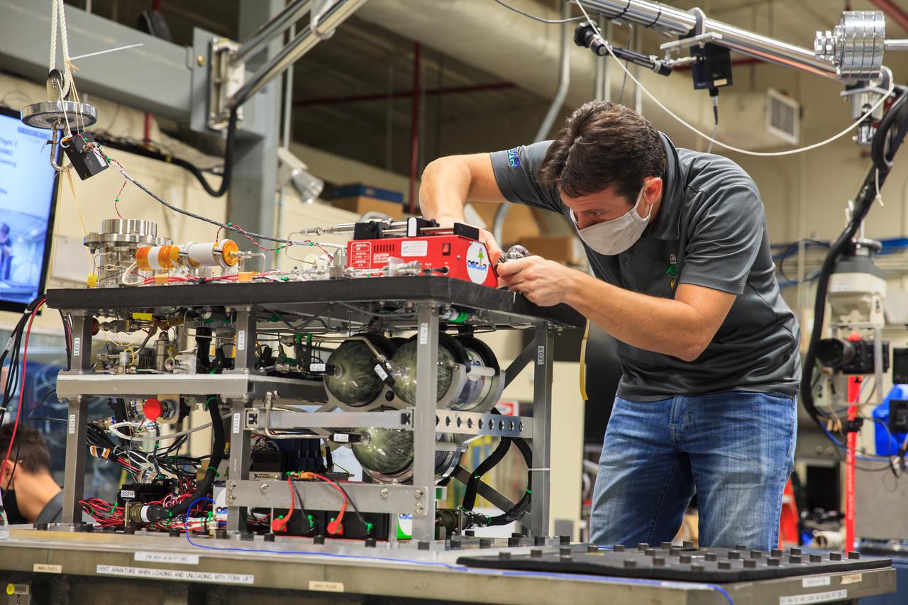 Gino Carro, a pressure vessels and systems engineer for Kennedy Space Center’s Laboratory Support Services and Operations contract, prepares NASA’s Orbital Syngas Commodity Augmentation Reactor (OSCAR) for vibration tests inside the Vibration Test Lab at the Florida spaceport on Jan. 14, 2021. The tests are part of ongoing preparation for a scheduled suborbital flight test later this year. Beginning as an Early Career Initiative project, OSCAR studies technology to convert trash and human waste into useful gasses such as methane, hydrogen, and carbon dioxide. By processing small pieces of trash in a high-temperature reactor, OSCAR would reduce the amount of space needed for waste storage within a spacecraft, turn some waste into gasses that have energy storage and life support applications, and ensure waste is no longer biologically active.