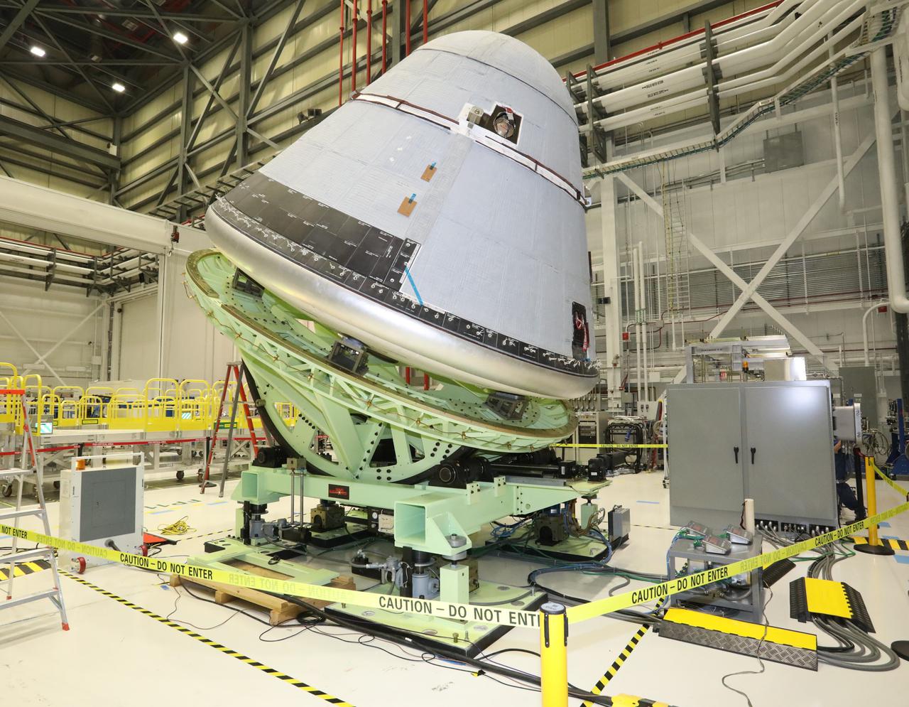 Boeing’s Starliner crew module is weighed in the Commercial Crew and Cargo Processing Facility at Kennedy Space Center in Florida on Jan. 14, 2021, in preparation for the company’s second Orbital Flight Test (OFT-2), as part of NASA’s Commercial Crew Program.. The Weight and Center of Gravity test measures the weight and balance of the spacecraft to ensure optimal performance during launch and re-entry. The test helps to validate parameters required for launching on United Launch Alliance’s Atlas V rocket, docking to the International Space Station and for navigation of the vehicle, among others.