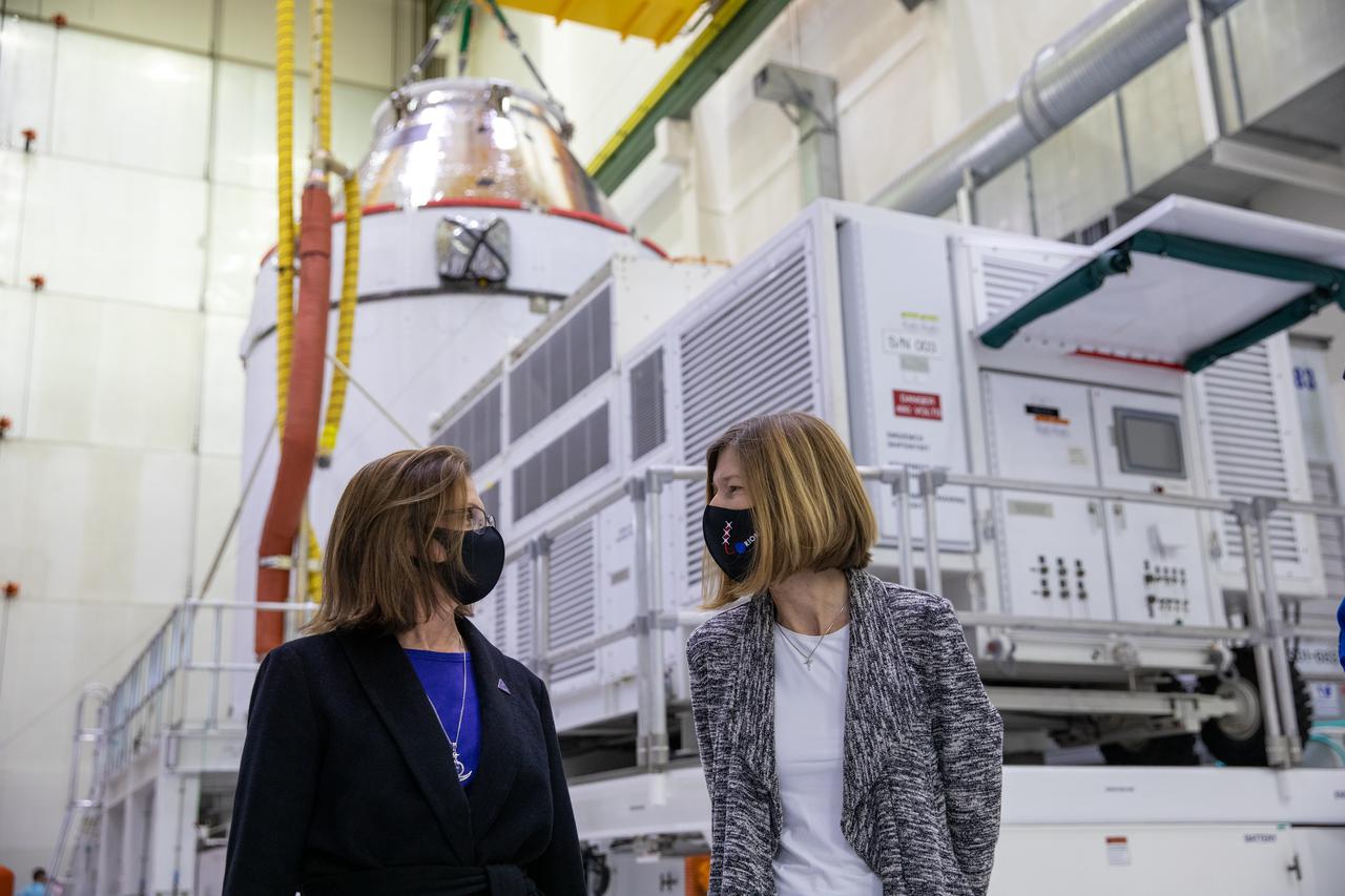 Orion is revealed for one of the final times on Jan. 14, as it is readied atop its transport pallet from the Neil Armstrong Operations and Checkout Building at NASA’s Kennedy Space Center in Florida, along its path to the pad ahead of the Artemis I launch. Viewing Orion in the high bay, from left, are Cathy Koerner, Orion Program Manager, and Kathy Lueders, associated administrator of the Human Exploration and Operations Mission Directorate. Teams across the globe have worked tirelessly to assemble the spacecraft, which will receive a protective covering prior to departing for the Multi-Payload Processing Facility to begin ground processing by the Exploration Ground Systems and Jacobs teams.