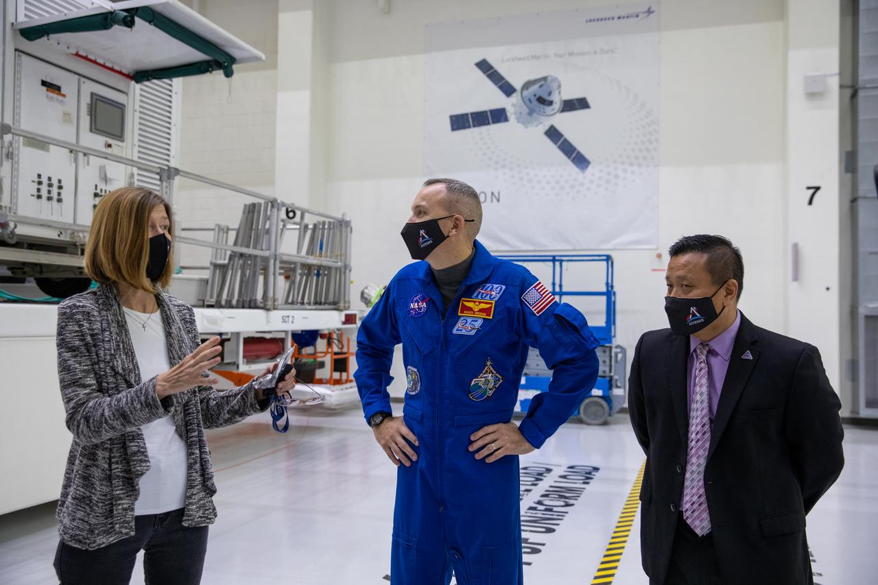 Orion is revealed for one of the final times on Jan. 14, as it is readied atop its transport pallet from the Neil Armstrong Operations and Checkout Building at NASA’s Kennedy Space Center in Florida, along its path to the pad ahead of the Artemis I launch. Touring the high bay, from left, are Kathy Lueders, associate administrator of the Human Exploration and Operations Mission Directorate, NASA astronaut Randy Bresnik, and Howard Hu, Orion Deputy Program manager. Teams across the globe have worked tirelessly to assemble the spacecraft, which will receive a protective covering prior to departing for the Multi-Payload Processing Facility to begin ground processing by the Exploration Ground Systems and Jacobs teams.