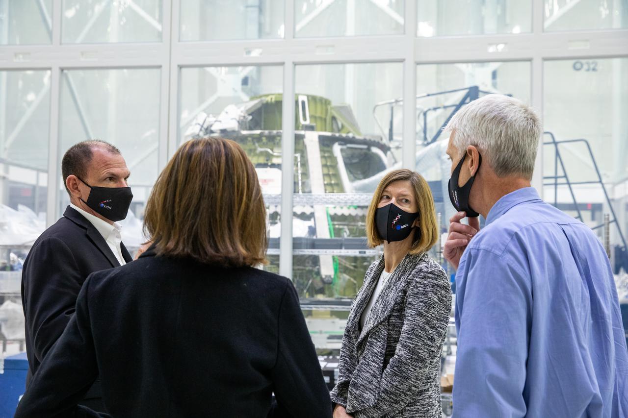 Kathy Lueders, second from right, associate administrator of the Human Exploration and Operations Mission Directorate, tours the Neil Armstrong Operations and Checkout Building high bay at NASA’s Kennedy Space Center in Florida on Jan. 14, 2021. In the background is the Orion crew module for the Artemis II mission. From left are Tony Antonelli, Lockheed Martin Orion Program director and Artemis II Mission director; Cathy Koerner, Orion Program manager; and Scott Wilson, Orion Production Operations manager. The group also viewed the Orion spacecraft for Artemis I as it was lowered onto a transporter for the move to the Multi-Payload Processing Facility to begin ground processing by the Exploration Ground Systems and Jacobs teams.