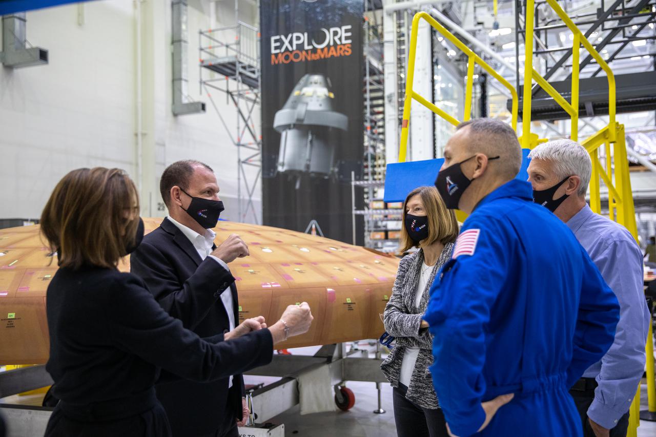 Kathy Lueders, third from right, associate administrator of the Human Exploration and Operations Mission Directorate, tours the Neil Armstrong Operations and Checkout Building high bay at NASA’s Kennedy Space Center in Florida on Jan. 14, 2021. In the background is the heat shield for the Orion crew module for the Artemis II mission. From left are Cathy Koerner, Orion Program manager; Tony Antonelli, Lockheed Martin Orion Program director and Artemis II Mission director; NASA astronaut Randy Bresnik; and Scott Wilson, Orion Production Operations manager. The group also viewed the Orion spacecraft for Artemis I as it was lowered onto a transporter for the move to the Multi-Payload Processing Facility to begin ground processing by the Exploration Ground Systems and Jacobs teams.