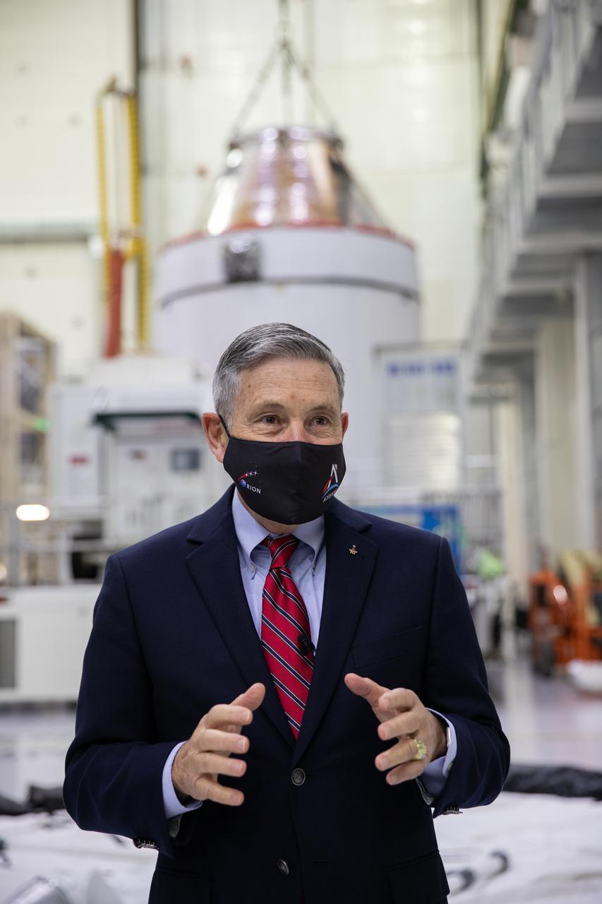 Orion is revealed for one of the final times on Jan. 14, as it is readied atop its transport pallet from the Neil Armstrong Operations and Checkout Building at NASA’s Kennedy Space Center in Florida, along its path to the pad ahead of the Artemis I launch. Kennedy Center Director Bob Cabana speaks to workers in front of Orion in the high bay. Teams across the globe have worked tirelessly to assemble the spacecraft, which will receive a protective covering prior to departing for the Multi-Payload Processing Facility to begin ground processing by the Exploration Ground Systems and Jacobs teams.