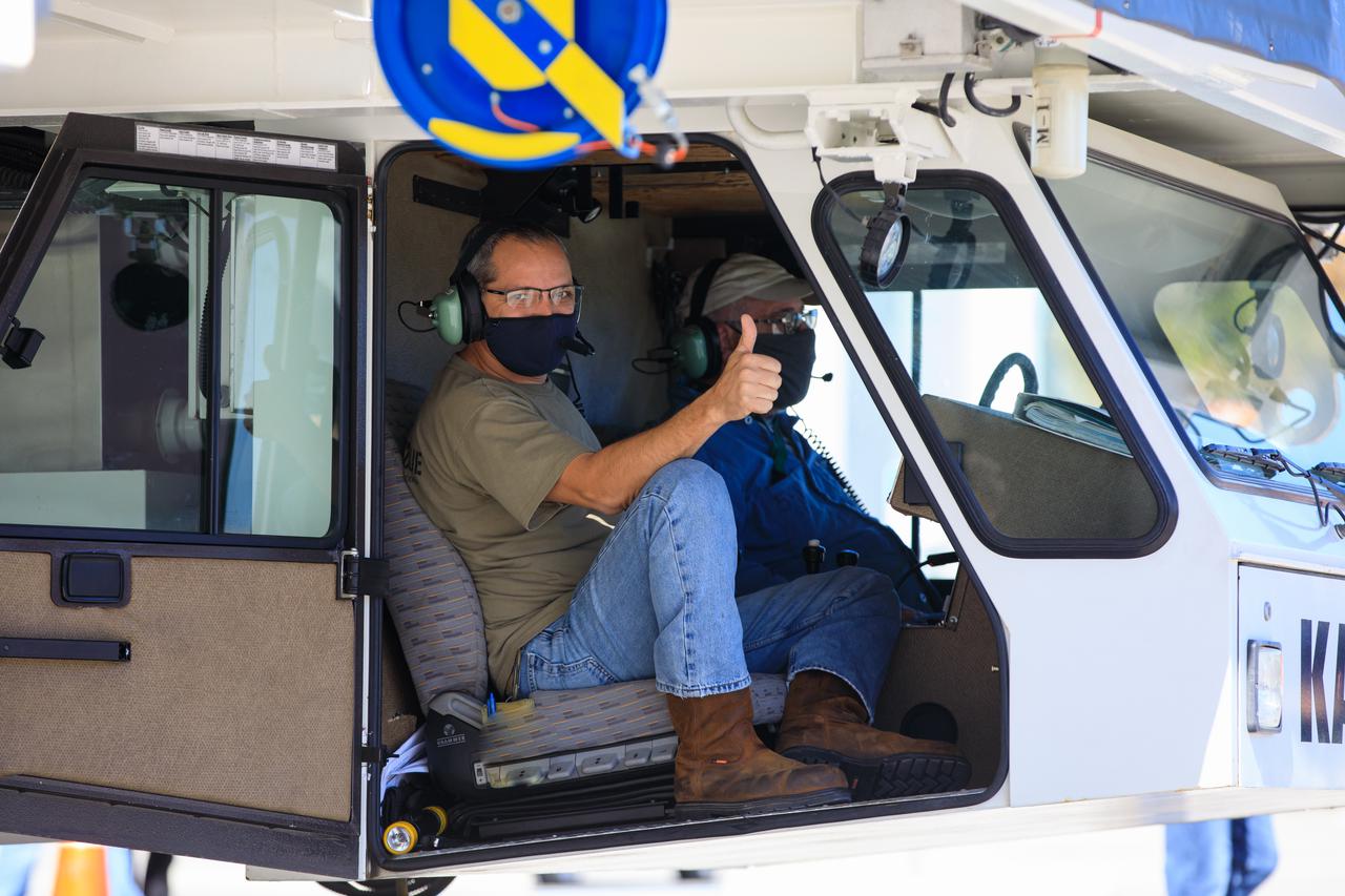 Ryan Kiechle of Jacobs Technology gives a thumbs-up inside the transporter with Orion secured atop as the spacecraft prepares to depart the Neil Armstrong Operations and Checkout Building at NASA’s Kennedy Space Center in Florida on Jan.16, 2021. Orion’s next stop will be the Multi-Payload Processing Facility where it will undergo ground processing with the Exploration Ground Systems team taking over ground processing ahead of the Artemis I launch.