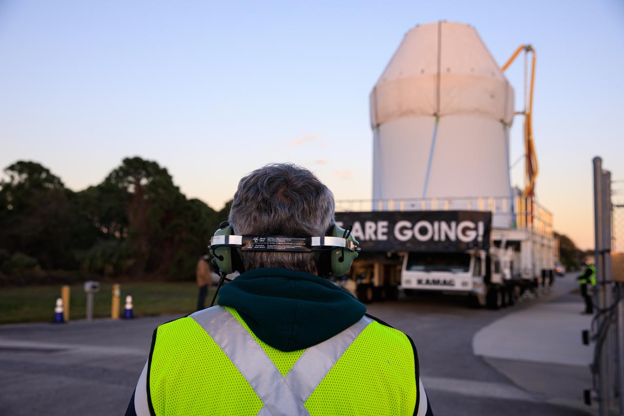 Secured atop a transport vehicle, Orion moves along the route to the Multi-Payload Processing Facility (MPPF) on Jan. 16, 2021, after departing from the Neil Armstrong Operations and Checkout Building at NASA’s Kennedy Space Center in Florida. In the MPPF, Orion will undergo processing with the Exploration Ground Systems team taking over ground processing ahead of the Artemis I launch.