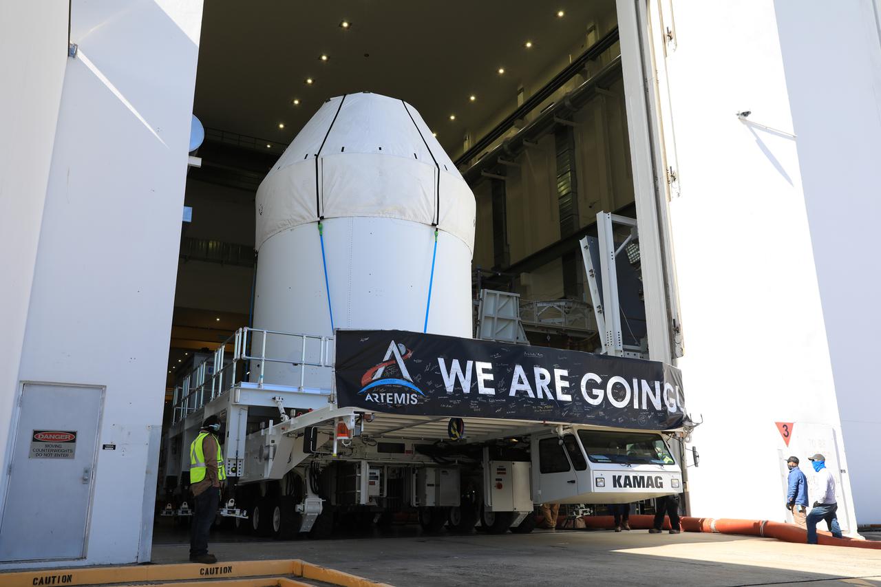 Orion is buttoned up and ready to march towards the Multi-Payload Processing Facility to begin ground processing by the Exploration Ground Systems and Jacobs teams ahead of the Artemis I launch. Shielded by a protective covering for transport, the spacecraft departs its home at the Neil Armstrong Operations and Checkout Building at NASA's Kennedy Space Center in Florida on Jan. 16, 2021.