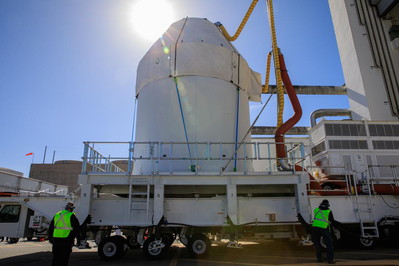 Orion sits atop a transport vehicle as it departs from its home at the Neil Armstrong Operations and Checkout Building at NASA’s Kennedy Space Center in Florida on Jan.16, 2021. Orion will begin its trek to the Multi-Payload Processing Facility. There it will undergo ground processing with the Exploration Ground Systems team taking over ground processing ahead of the Artemis I launch.