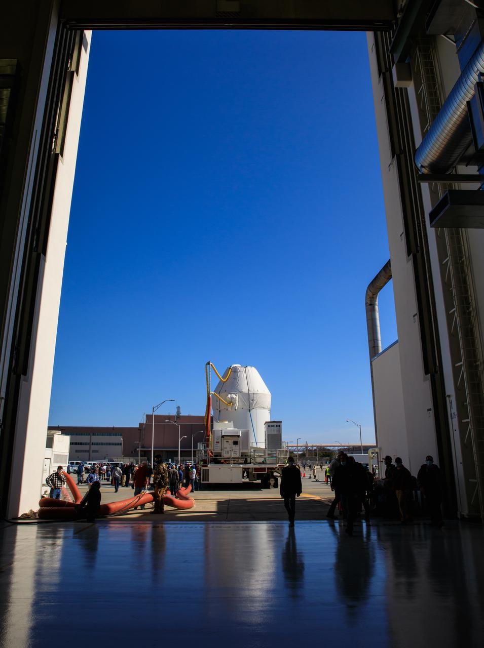Orion sits atop a transport vehicle as it departs from its home at the Neil Armstrong Operations and Checkout Building at NASA’s Kennedy Space Center in Florida on Jan.16, 2021. Orion will begin its trek to the Multi-Payload Processing Facility. There it will undergo ground processing with the Exploration Ground Systems team taking over ground processing ahead of the Artemis I launch.