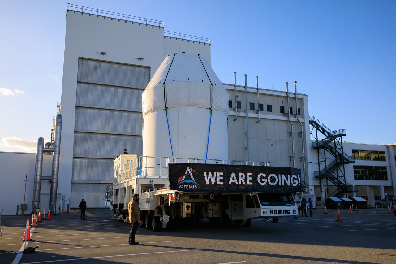 Orion sits atop a transport vehicle as it departs from its home at the Neil Armstrong Operations and Checkout Building at NASA’s Kennedy Space Center in Florida on Jan.16, 2021. Orion’s next stop will be the Multi-Payload Processing Facility where it will undergo ground processing with the Exploration Ground Systems team taking over ground processing ahead of the Artemis I launch.
