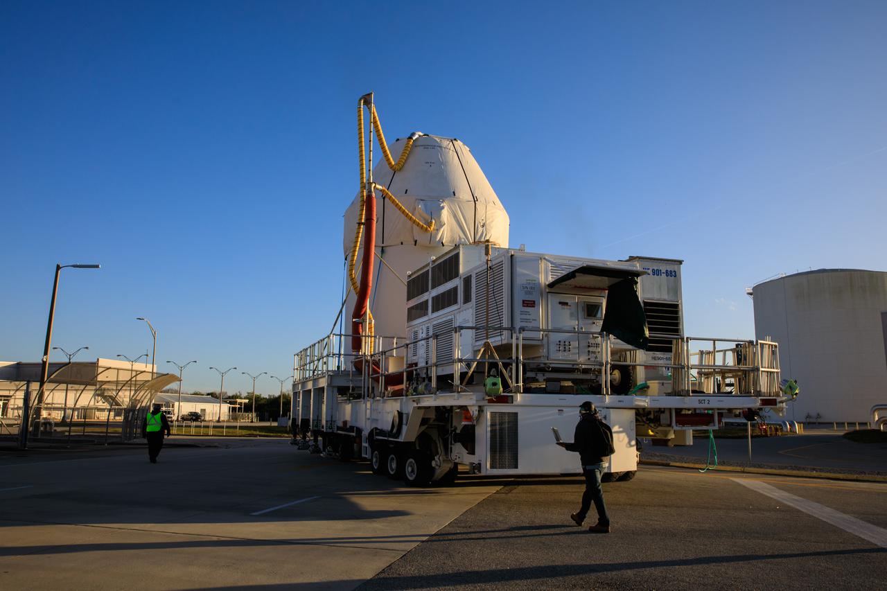 Orion sits atop a transport vehicle as it departs from its home at the Neil Armstrong Operations and Checkout Building at NASA’s Kennedy Space Center in Florida on Jan.16, 2021. Orion’s next stop will be the Multi-Payload Processing Facility where it will undergo ground processing with the Exploration Ground Systems team taking over ground processing ahead of the Artemis I launch.
