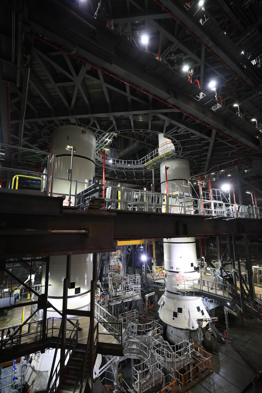 In High Bay 3 of the Vehicle Assembly Building at NASA’s Kennedy Space Center in Florida, the left-hand center center booster segment for Artemis I is lowered onto the center aft booster segment on the mobile launcher for the Space Launch System (SLS) on Jan. 21, 2021. Workers with Exploration Ground Systems and contractor Jacobs teams will stack the twin five-segment boosters on the mobile launcher in High Bay 3 over a number of weeks. When the core stage arrives, it will join the boosters on the mobile launcher, followed by the interim cryogenic propulsion stage and Orion spacecraft. Manufactured by Northrop Grumman in Utah, the twin boosters provide more than 75 percent of the total SLS thrust at launch. The SLS is managed by Marshall Space Flight Center in Huntsville, Alabama. Under the Artemis program, NASA will land the first woman and the next man on the Moon by 2024. The first in a series of increasingly complex missions, Artemis I will test the Orion spacecraft and SLS as an integrated system ahead of crewed flights to the Moon.