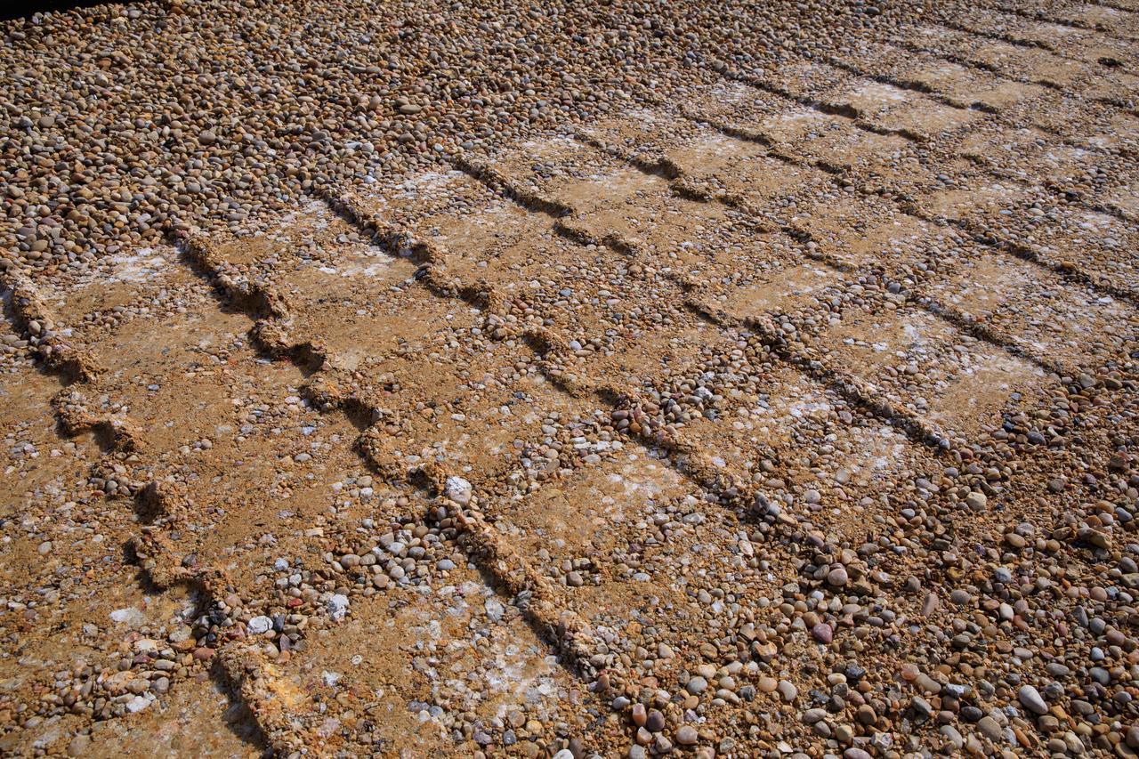 A close-up view of tread marks from crawler-transporter 2 (CT-2) as the behemoth vehicle moves along the crawlerway at NASA’s Kennedy Space Center in Florida on Jan. 22, 2021. Teams are working to ensure the crawlerway, the path the CT-2, mobile launcher, and Space Launch System rocket with Orion atop will take from the Vehicle Assembly Building to Launch Complex 39B, is strong enough to withstand the weight and provide stability for the Artemis I mission. CT-2 carrying mobile launcher platform 1, used during the shuttle program, was driven back and forth on the crawlerway with several cement blocks, each weighing about 40,000 pounds to strengthen the crawlerway for launch. Artemis I will be the first in a series of increasingly complex missions to the Moon. Under the Artemis program, NASA aims to land the first woman and the next man on the Moon in 2024 and establish sustainable lunar exploration by the end of the decade.