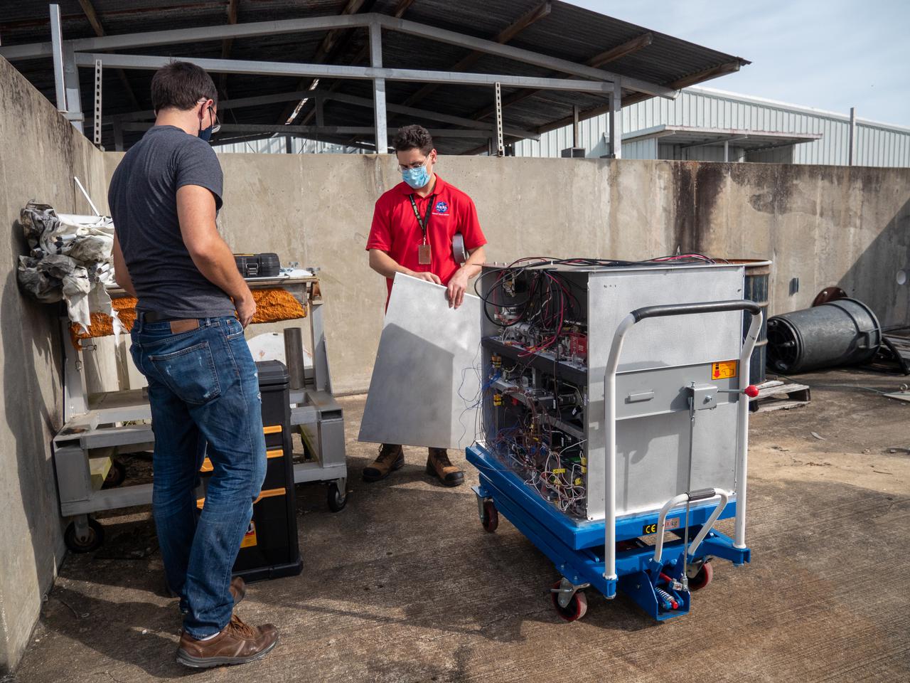 Chemical Engineer David Rinderknecht, left, and Ray Pitts, co-principal investigator for the Orbital Syngas Commodity Augmentation Reactor (OSCAR), prepare OSCAR for thermal testing Jan. 26, 2021, at NASA’s Kennedy Space Center in Florida. The tests are in preparation for a scheduled suborbital flight test later this year facilitated by NASA’s Flight Opportunities program. The testing ensures the thermal environment of the payload won’t create additional hazards during flight and that OSCAR can successfully operate within the temperature range it may encounter as it performs tests in microgravity.