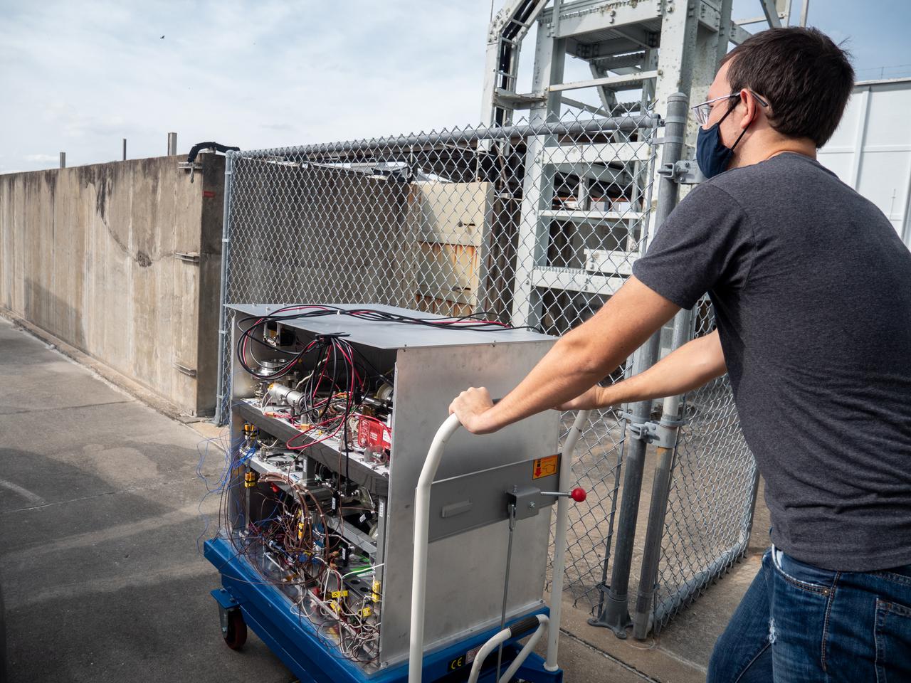 Chemical Engineer David Rinderknecht prepares the Orbital Syngas Commodity Augmentation Reactor (OSCAR) for thermal testing Jan. 26, 2021, at NASA’s Kennedy Space Center in Florida. The tests are in preparation for a scheduled suborbital flight test later this year facilitated by NASA’s Flight Opportunities program. The testing ensures the thermal environment of the payload won’t create additional hazards during flight and that OSCAR can successfully operate within the temperature range it may encounter as it performs tests in microgravity.