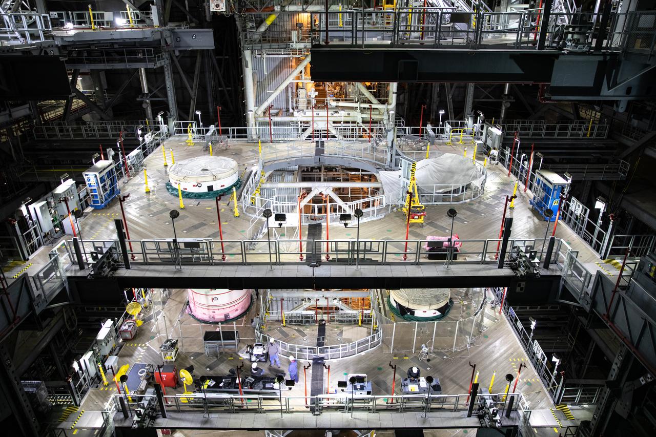 In High Bay 3 of the Vehicle Assembly Building at NASA’s Kennedy Space Center in Florida, the left-hand forward center booster segment for Artemis I is lowered onto the center center booster segment on the mobile launcher for the Space Launch System (SLS) on Jan. 29, 2021. Workers with Exploration Ground Systems and contractor Jacobs teams will stack the twin five-segment boosters on the mobile launcher in High Bay 3 over a number of weeks. When the core stage arrives, it will join the boosters on the mobile launcher, followed by the interim cryogenic propulsion stage and Orion spacecraft. Manufactured by Northrop Grumman in Utah, the twin boosters provide more than 75 percent of the total SLS thrust at launch. The SLS is managed by Marshall Space Flight Center in Huntsville, Alabama. Under the Artemis program, NASA will land the first woman and the next man on the Moon by 2024. The first in a series of increasingly complex missions, Artemis I will test the Orion spacecraft and SLS as an integrated system ahead of crewed flights to the Moon.