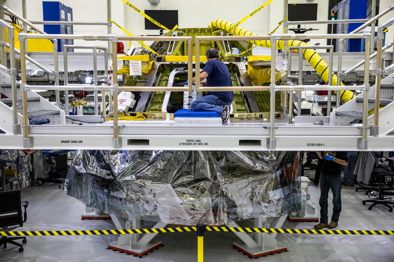 Inside the Neil Armstrong Operations and Checkout Building high bay at NASA's Kennedy Space Center in Florida, assembly continues on Orion’s Artemis II crew module on Feb. 5, 2021. The capsule will house astronauts during its mission around the Moon. Recently, teams removed the spacecraft from its clean room environment, where they have been performing the buildup of the Environmental Control and Propulsion System (ECPS) prior to their installation into the crew module. It will return to the clean room to complete ECPS final welds and assemblies. Artemis II will confirm all of the Orion spacecraft’s systems operate as designed in the actual environment of deep space with astronauts aboard. As part of the Artemis Program, NASA will send the first woman and next man to the Moon.