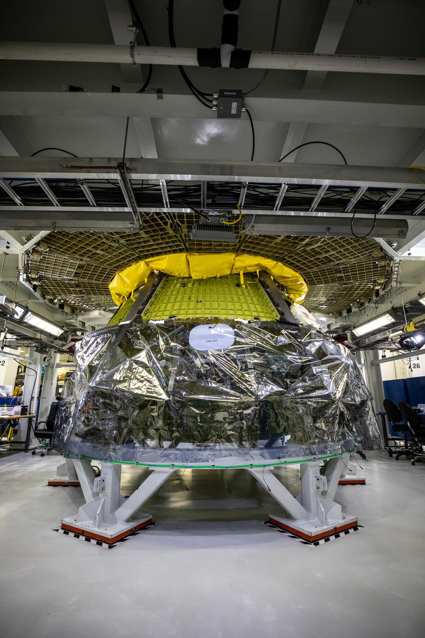 Inside the Neil Armstrong Operations and Checkout Building high bay at NASA's Kennedy Space Center in Florida, assembly continues on Orion’s Artemis II crew module on Feb. 5, 2021. The capsule will house astronauts during its mission around the Moon. Recently, teams removed the spacecraft from its clean room environment, where they have been performing the buildup of the Environmental Control and Propulsion System (ECPS) assemblies prior to their installation into the crew module. It will return to the clean room to complete ECPS final welds and assemblies. Artemis II will confirm all of the Orion spacecraft’s systems operate as designed in the actual environment of deep space with astronauts aboard. As part of the Artemis Program, NASA will send the first woman and next man to the Moon.
