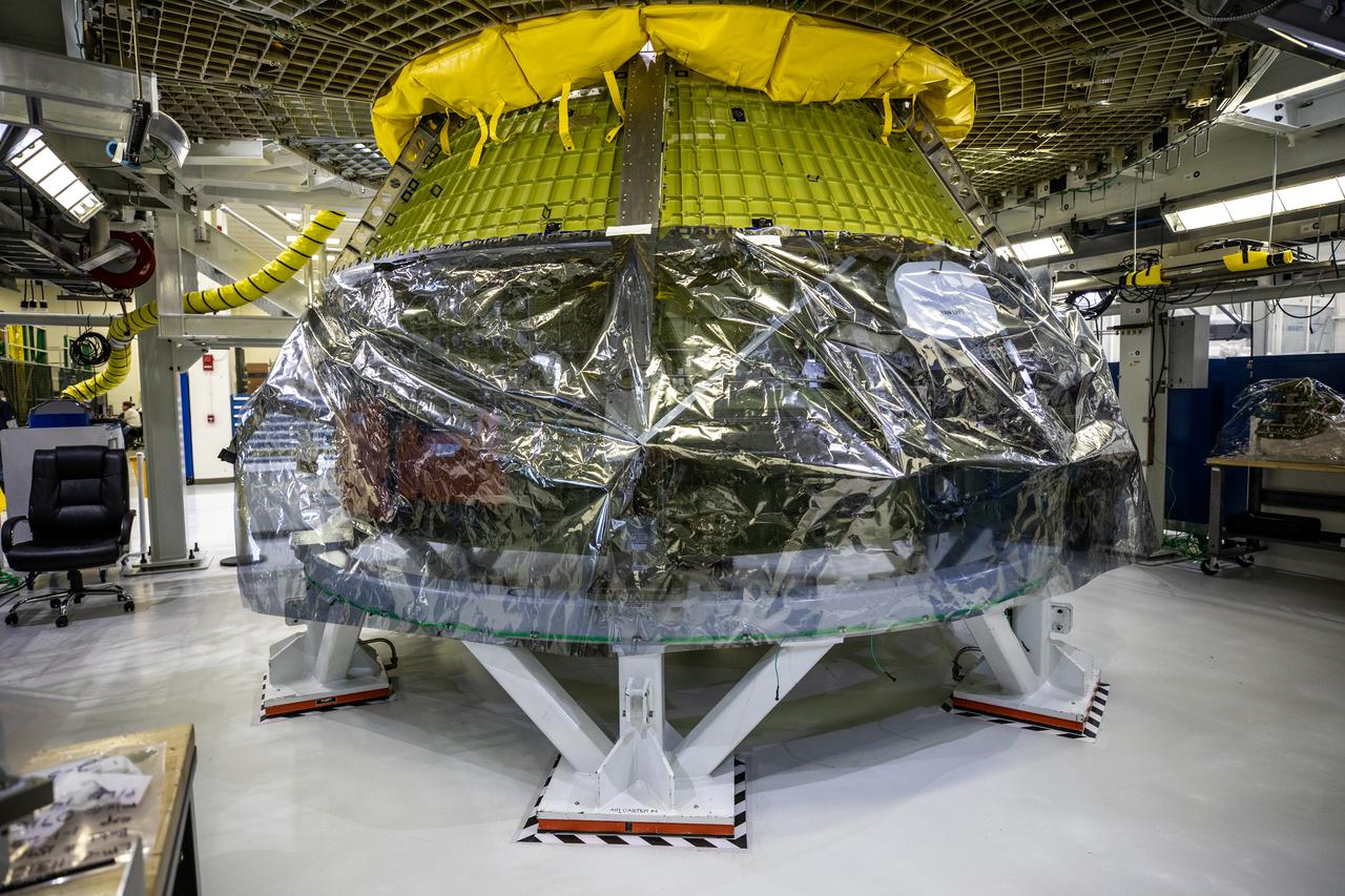 A close-up view of Orion’s Artemis II crew module inside the Neil Armstrong Operations and Checkout Building high bay at NASA's Kennedy Space Center in Florida, on Feb. 5, 2021. The capsule will house astronauts during its mission around the Moon. Recently, teams removed the spacecraft from its clean room environment, where they have been performing the buildup of the Environmental Control and Propulsion System (ECPS) assemblies prior to their installation into the crew module. It will return to the clean room to complete ECPS final welds and assemblies. Artemis II will confirm all of the Orion spacecraft’s systems operate as designed in the actual environment of deep space with astronauts aboard. As part of the Artemis Program, NASA will send the first woman and next man to the Moon.
