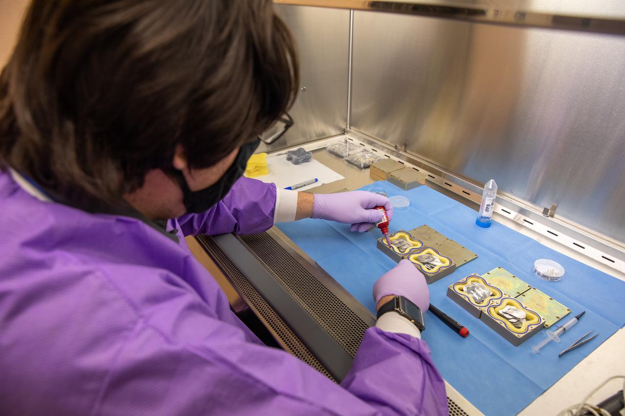Cory Spern, a research scientist working with the Exploration Research and Technology programs at NASA’s Kennedy Space Center in Florida, prepares containers Feb. 11, 2021, for a Materials International Space Station Experiment (MISSE). The containers, carrying sets of seeds, will fly aboard Northrop Grumman’s Cygnus spacecraft as part of NG-15, a NASA commercial resupply mission to the orbiting laboratory targeted for Feb. 20, 2021. They will be placed in the MISSE testing facility, located near the space station’s solar arrays, where they will be exposed to the extreme environment of space for six months before returning to Earth for further study.