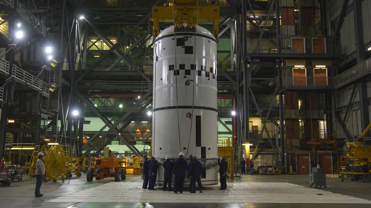 The left-hand forward segment for NASA’s Space Launch System (SLS) is in the transfer aisle of the Vehicle Assembly Building at NASA’s Kennedy Space Center in Florida on Feb. 18, 2021. Workers will use a crane to lift the segment up and transfer it into High Bay 3, where it will be attached to the center forward segment on the mobile launcher. Workers with Exploration Ground Systems and contractor Jacobs teams are stacking the twin five-segment boosters on the ML over a number of weeks. When the core stage arrives, it will join the boosters on the mobile launcher, followed by the interim cryogenic propulsion stage and Orion spacecraft. Manufactured by Northrop Grumman in Utah, the twin boosters provide more than 75 percent of the total SLS thrust at launch. The SLS is managed by Marshall Space Flight Center in Huntsville, Alabama. Under the Artemis program, NASA will land the first woman and the next man on the Moon by 2024. The first in a series of increasingly complex missions, Artemis I will test the Orion spacecraft and SLS as an integrated system ahead of crewed flights to the Moon.
