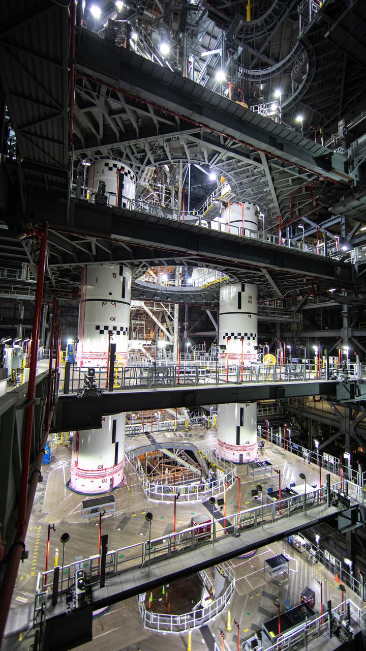 Inside High Bay 3 of the Vehicle Assembly Building at NASA’s Kennedy Space Center in Florida, a crane lowers the right-hand forward segment onto the center forward segment on Feb. 23, 2021. Workers with Exploration Ground Systems and contractor Jacobs are completing the stacking of the twin solid rocket boosters on the mobile launcher for NASA’s Space Launch System (SLS). When the core stage arrives, it will join the boosters on the mobile launcher, followed by the interim cryogenic propulsion stage and Orion spacecraft. Manufactured by Northrop Grumman in Utah, the twin boosters provide more than 75 percent of the total SLS thrust at launch. The SLS is managed by Marshall Space Flight Center in Huntsville, Alabama. Under the Artemis program, NASA will land the first woman and the next man on the Moon by 2024. The first in a series of increasingly complex missions, Artemis I will test the Orion spacecraft and SLS as an integrated system ahead of crewed flights to the Moon.