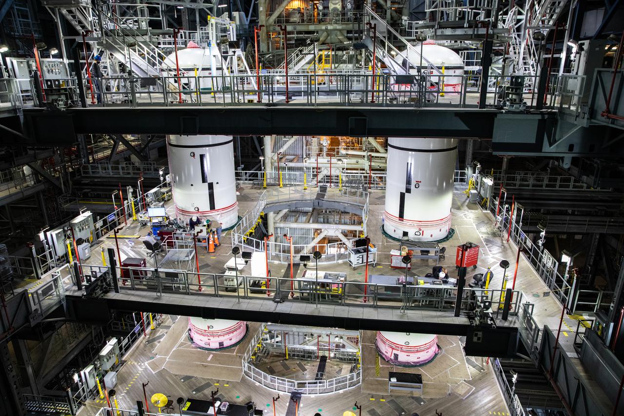 In High Bay 3 of the Vehicle Assembly Building at NASA’s Kennedy Space Center in Florida, the left-hand and right-hand forward segments are secured on top of the center forward segments on the mobile launcher (ML) for the Space Launch System (SLS) on Feb. 24, 2021. Workers with Exploration Ground Systems and contractor Jacobs teams are stacking the twin five-segment boosters on the ML over a number of weeks. When the core stage arrives, it will join the boosters on the mobile launcher, followed by the interim cryogenic propulsion stage and Orion spacecraft. Manufactured by Northrop Grumman in Utah, the twin boosters provide more than 75 percent of the total SLS thrust at launch. The SLS is managed by Marshall Space Flight Center in Huntsville, Alabama. Under the Artemis program, NASA will land the first woman and the next man on the Moon by 2024. The first in a series of increasingly complex missions, Artemis I will test the Orion spacecraft and SLS as an integrated system ahead of crewed flights to the Moon.